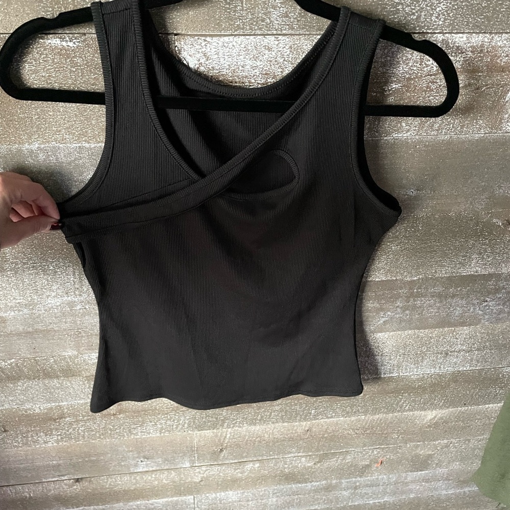 Black sleeveless tank top with v-neck asymmetrical cut out design